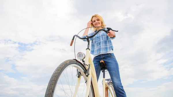骑自行车如何改变你的生活，让你快乐。骑自行车的理由。精神健康福利。走向幸福的踏板。女孩骑自行车的天空背景。女人骑自行车时感到快乐 — 图库照片