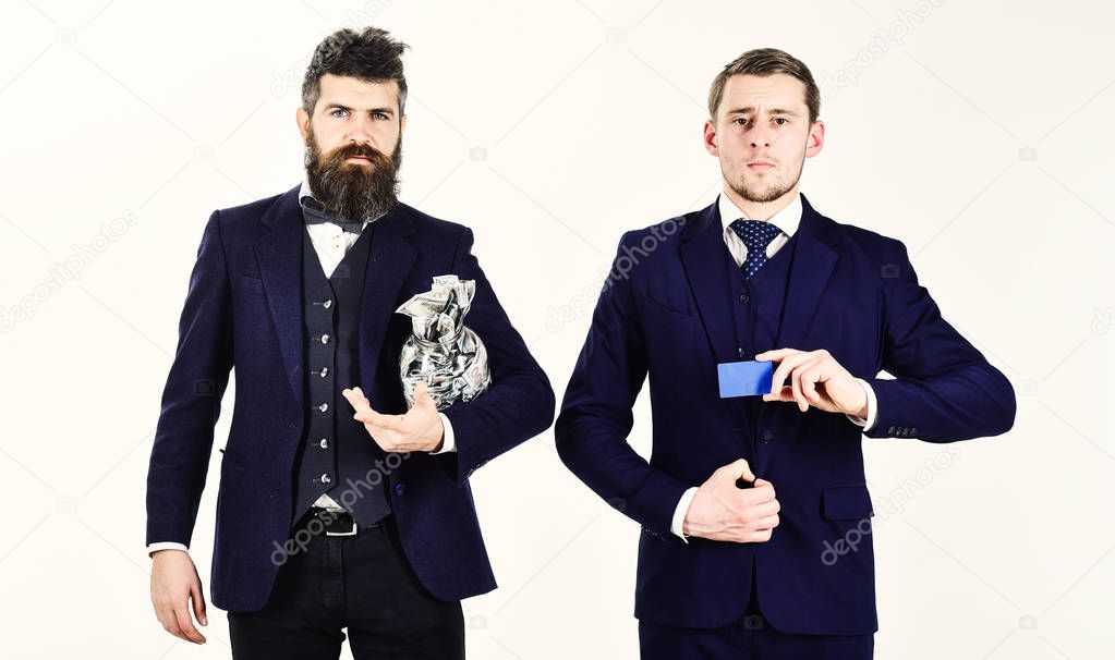 Men in suit, businessmen with jar full of cash and credit card, white background. Mature man got loan, modern guy holds credit card, electronic money, copy space. Loan and banking concept