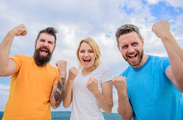 Celebrate success. We can do it. Ways to build successful team. Behaviors of winner team. Woman and men look successful celebrate victory sky background. Threesome stand happy with raised fists