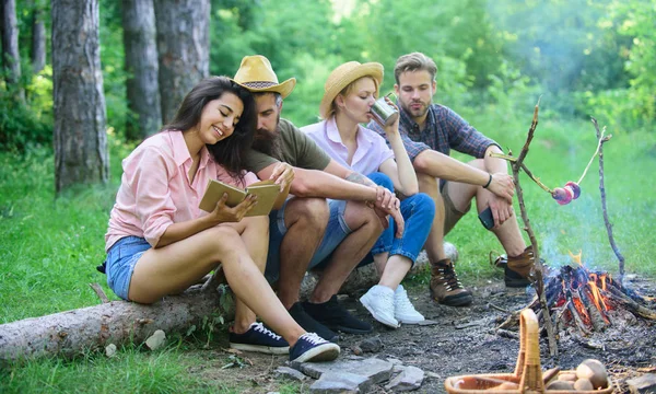Company friends spend great time picnic or barbecue near bonfire. Group friends spend leisure weekend hike picnic forest nature background. Friends enjoy weekend barbecue in forest. Idyllic weekend
