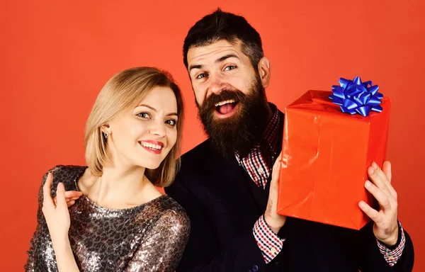 Paar in de liefde aandelen presenteert op rode achtergrond. — Stockfoto