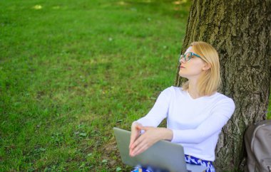 Save your time with virtual education. Student surfing internet in park. Student prepare project. Woman laptop park study online. Girl sit grass with notebook. Girl take advantage virtual education clipart