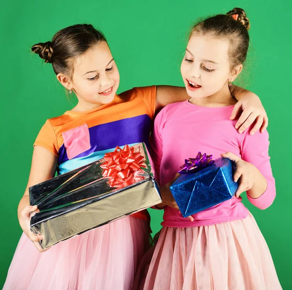 New Year presents concept. Sisters with wrapped gift boxes
