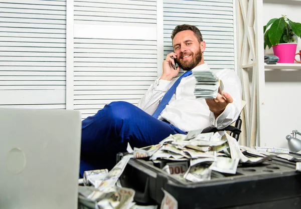 Man successful businessman phone conversation ask service. Businessman rich bearded guy sit office with lot of cash money. Bank loan or credit. Get cash in few minutes. Banking support line concept