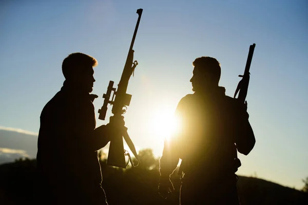 Jägerfreund genießt Freizeit. Jäger Freunde Wildhüter mit Waffen Silhouette Himmel Hintergrund. Jäger schützen die Natur. Jagd mit Partner sorgt für mehr Sicherheit Spaß und Belohnung — Stockfoto