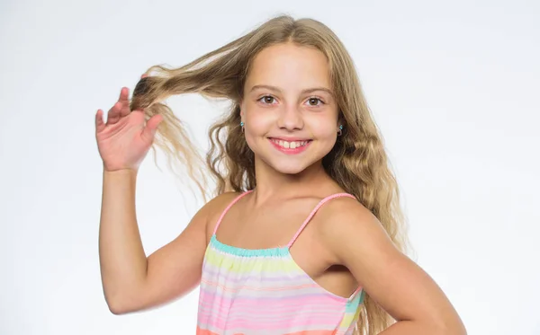 Natural beauty. Teaching your child healthy hair care habits. Hair care tips for kids. Kid little girl happy look at camera. How to care for childs hair. Girl long hair smiling face white background.