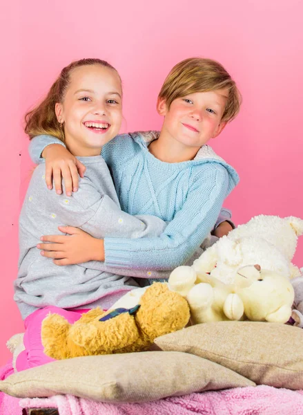 Kids siblings friends hug pink background. Children friends near teddy bear soft toys cuddling. Girl and boy friends cheerful mood hug each other. Friendship concept. Best friends brother and sister — Stock Photo, Image
