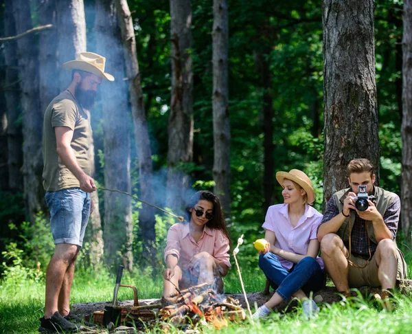 Camping and hiking. Company friends relaxing and having snack picnic nature background. Company hikers relaxing at picnic forest background. Spend great time on weekend. Take a break to have snack