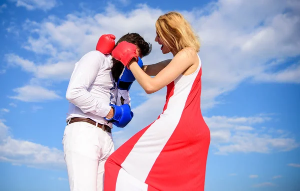 Learn how to defend yourself. Man and woman boxing gloves fight sky background. She knows how to defend herself. Girl confident in strength power. Struggle equality rights. Gender domination concept