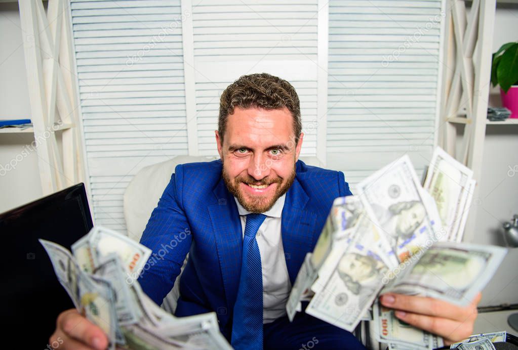 Earn money easy business tips. Man cheerful happy businessman with pile dollar banknotes. Profit and richness concept. Che k out my profit this month. Businessman formal suit hold cash dollars hands
