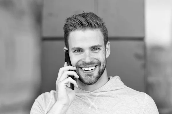 I was waiting for your call. Man beard with smartphone, urban background. Communication concept. Man with beard happy smiling face talk smartphone. Guy cheerful answer call on smartphone.