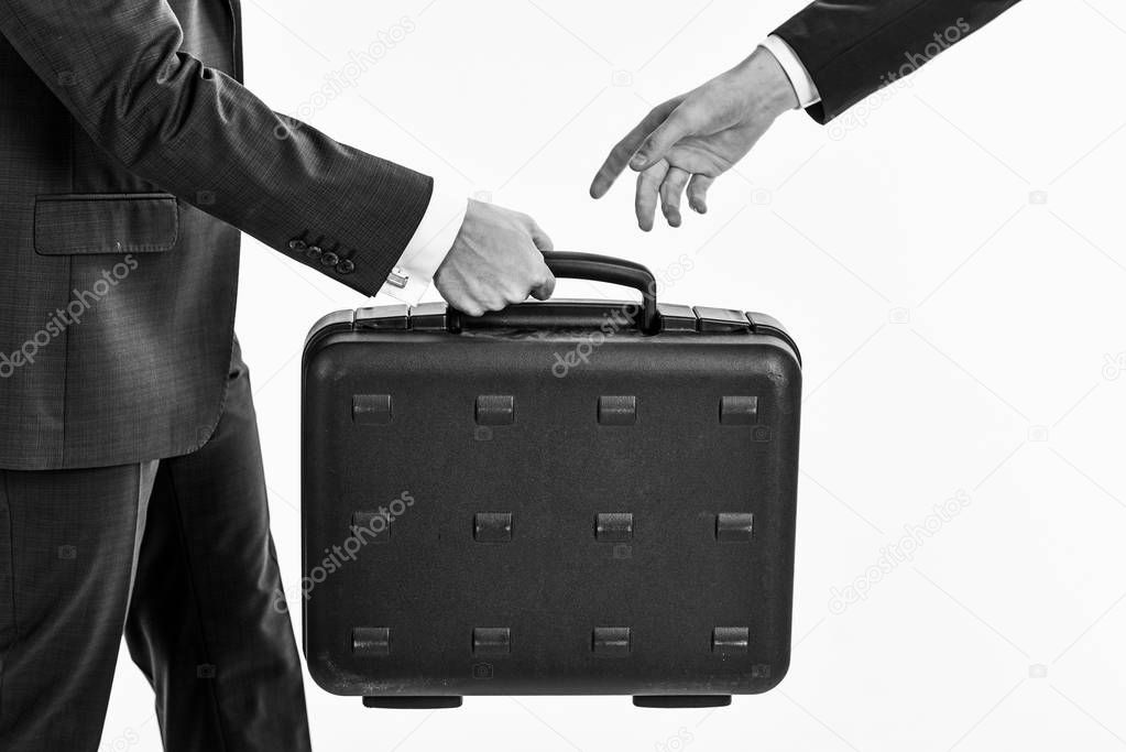 Male hand carry briefcase for exchange. Handover of case
