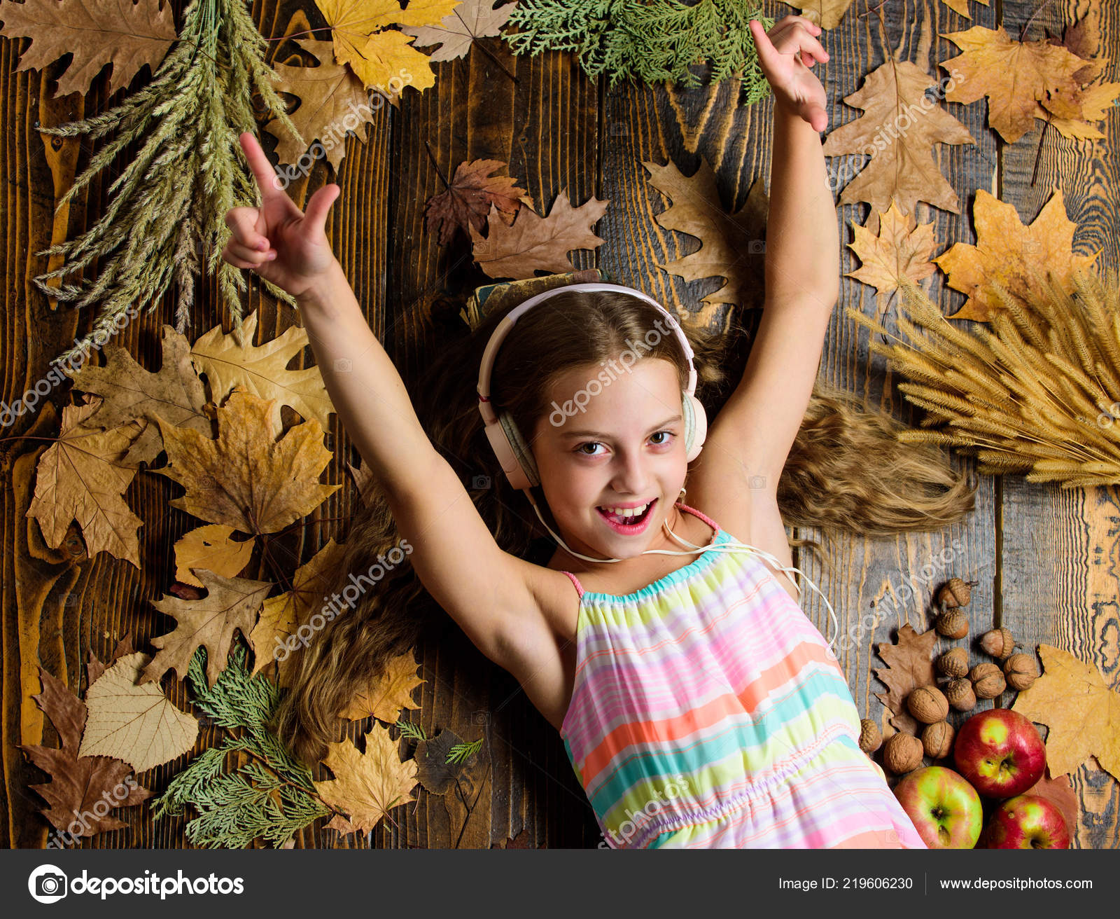 Kid girl wooden background listen music headphones child listen music relaxing top view autumn melody concept