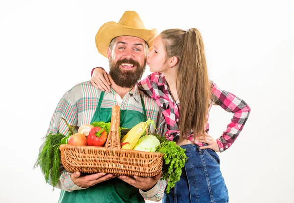 Father farmer or gardener with daughter hold basket harvest vegetables. Farmers family homegrown harvest. Gardening and harvesting. Family farm organic vegetables. Man bearded rustic farmer with kid