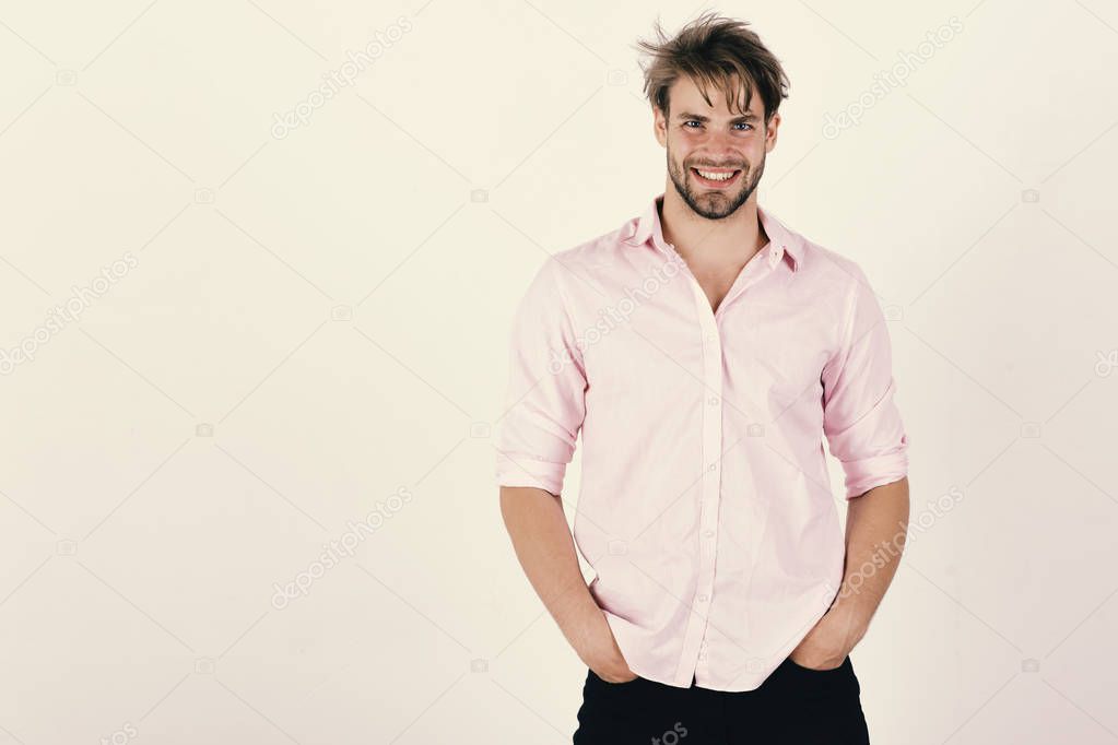 Guy with bristle in pink shirt and messy hair