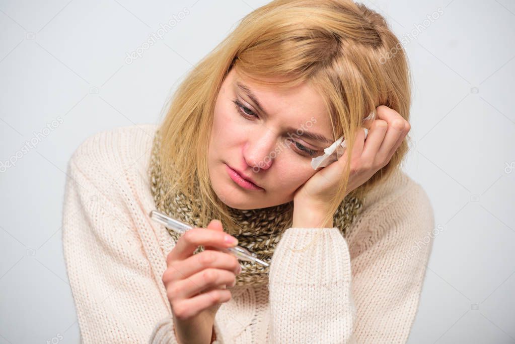 Woman feels badly ill sneezing. Girl in scarf hold thermometer and tissue close up. Measure temperature. Break fever remedies. Take temperature and assess symptoms. High temperature concept