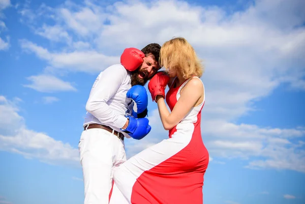 Man and woman fight boxing gloves sky background. Attack is best defence. Women can fight back concept. Defend your opinion in confrontation. Struggle for gender equality. Couple in love boxing