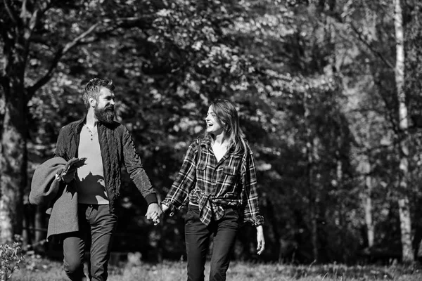 Couple in love walks in autumn park. Relationship and fall