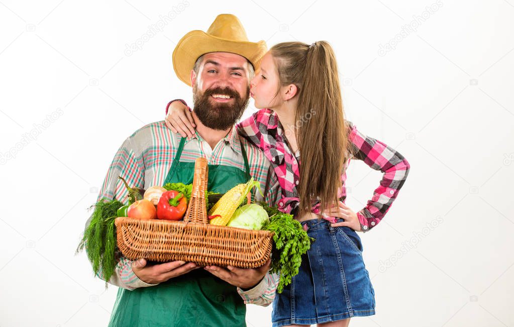 Man bearded rustic farmer with kid. Father farmer or gardener with daughter hold basket harvest vegetables. Farmers family homegrown harvest. Gardening and harvesting. Family farm organic vegetables