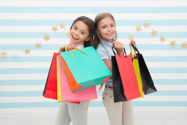 Çocuklar mutlu grup paketleri taşır. En iyi arkadaşım kavramı ile alışveriş. Kızlar alışveriş gibi. Çocuklar mutlu küçük kızlar alışveriş torbaları tutuşur. En iyi arkadaşı veya kız kardeşi ile alışverişin tadını çıkarın. Kız gibi mutluluk