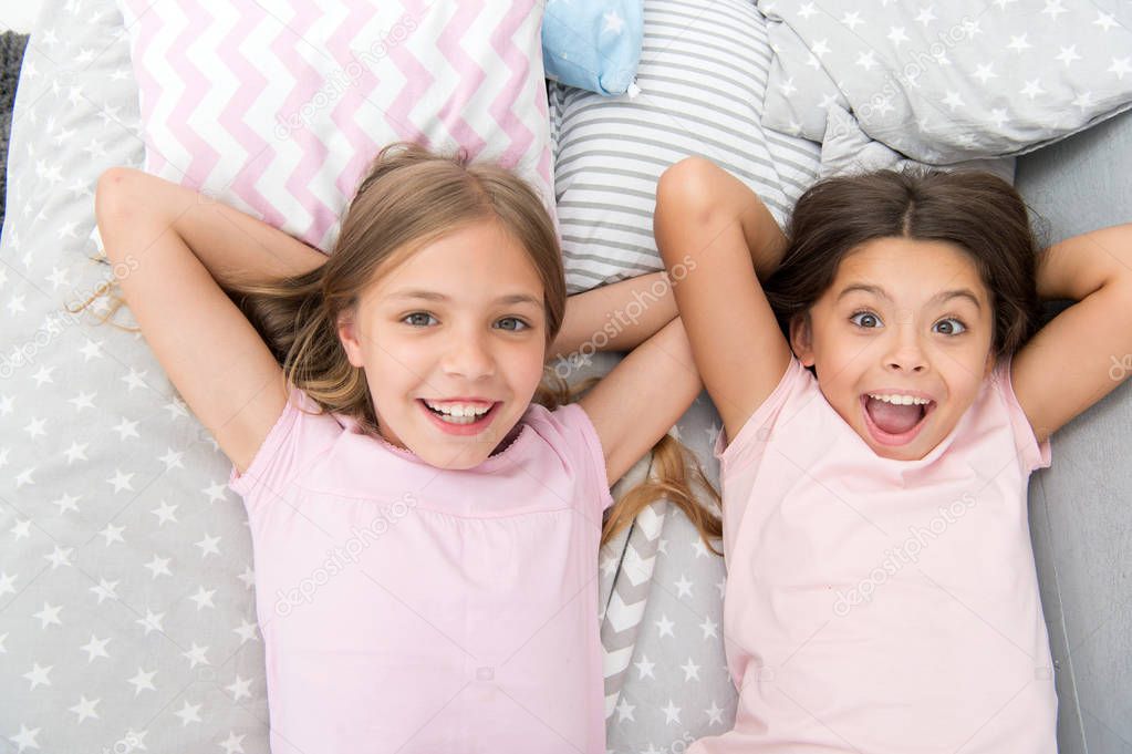 Consider theme slumber party. Slumber party timeless childhood tradition. Girls relaxing on bed. Slumber party concept. Girls just want to have fun. Invite friend for sleepover. Best friends forever