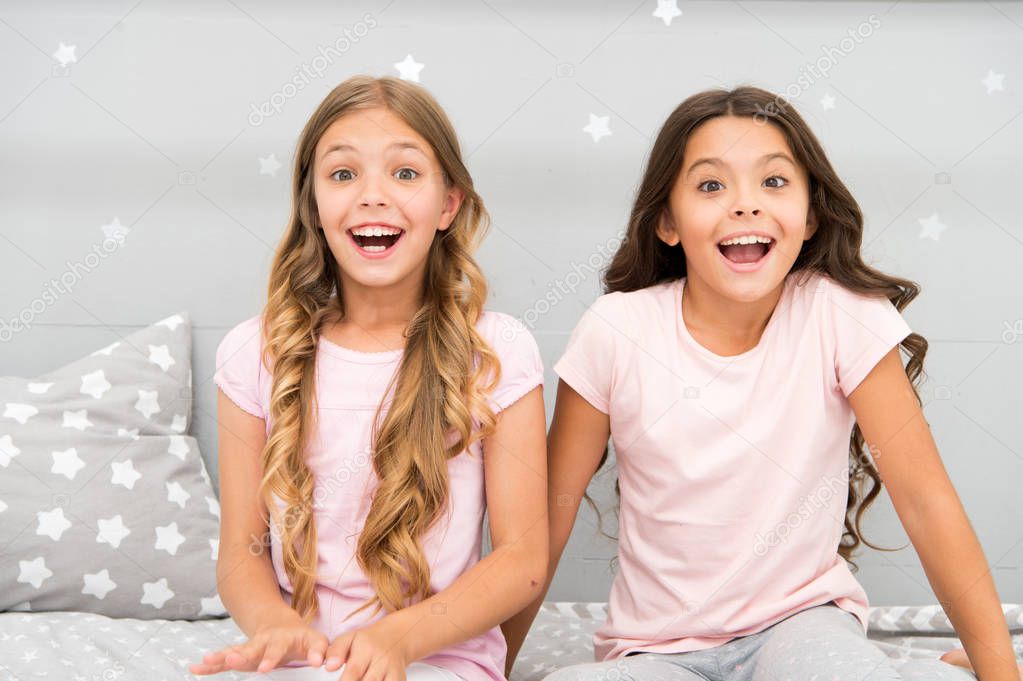 Joy and happiness. Happy together. Kids girls sisters best friends full of energy in cheerful mood. Good morning concept. Children cheerful play bedroom. Great start of day. Happy childhood moments
