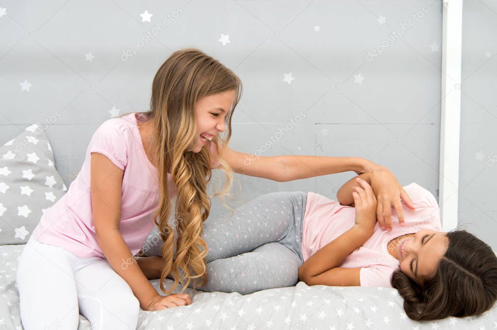 Children cheerful play bedroom. Happy childhood moments. Joy and happiness. Happy together. Kids girls sisters best friends full of energy in cheerful mood. Good morning concept. Great start of day
