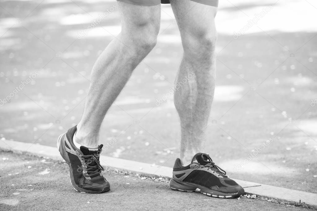 Legs of male athlete runner jogging park sidewalk. Active lifestyle training cardio sport shoes. Vascular disease varicose veins problems active life. Prevent varicose concept. Disease caused by run