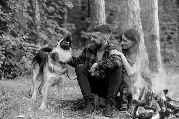 Couple in love, young happy family spend leisure with dog.