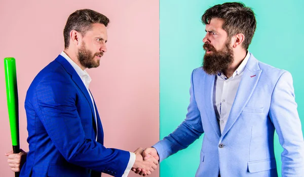 Do not trust him. Hidden danger. Businessman hides bat behind back while shaking hands. Hidden threat concept. Business partners competitors office colleagues shaking hands. Tricky first impression — Stock Photo, Image