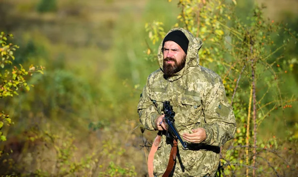 Harvest animals typically restricted. Hunting hobby concept. Experience and practice lends success hunting. Hunting season. Guy hunting nature environment. Bearded hunter rifle nature background