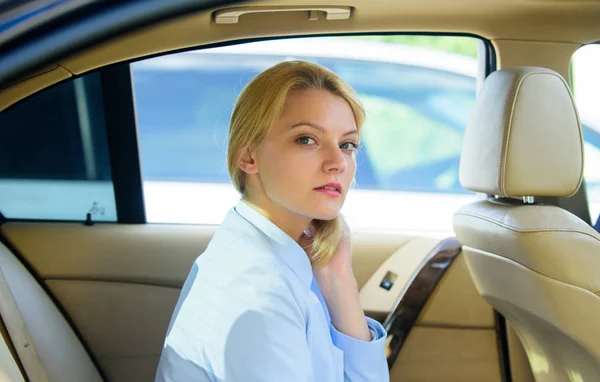 Business lady passenger luxury car salon. Personal assistant and driver. Business life concept. Business woman sit on backseat. Busy lady passenger leather car salon enjoy journey with chauffeur — Stock Photo, Image