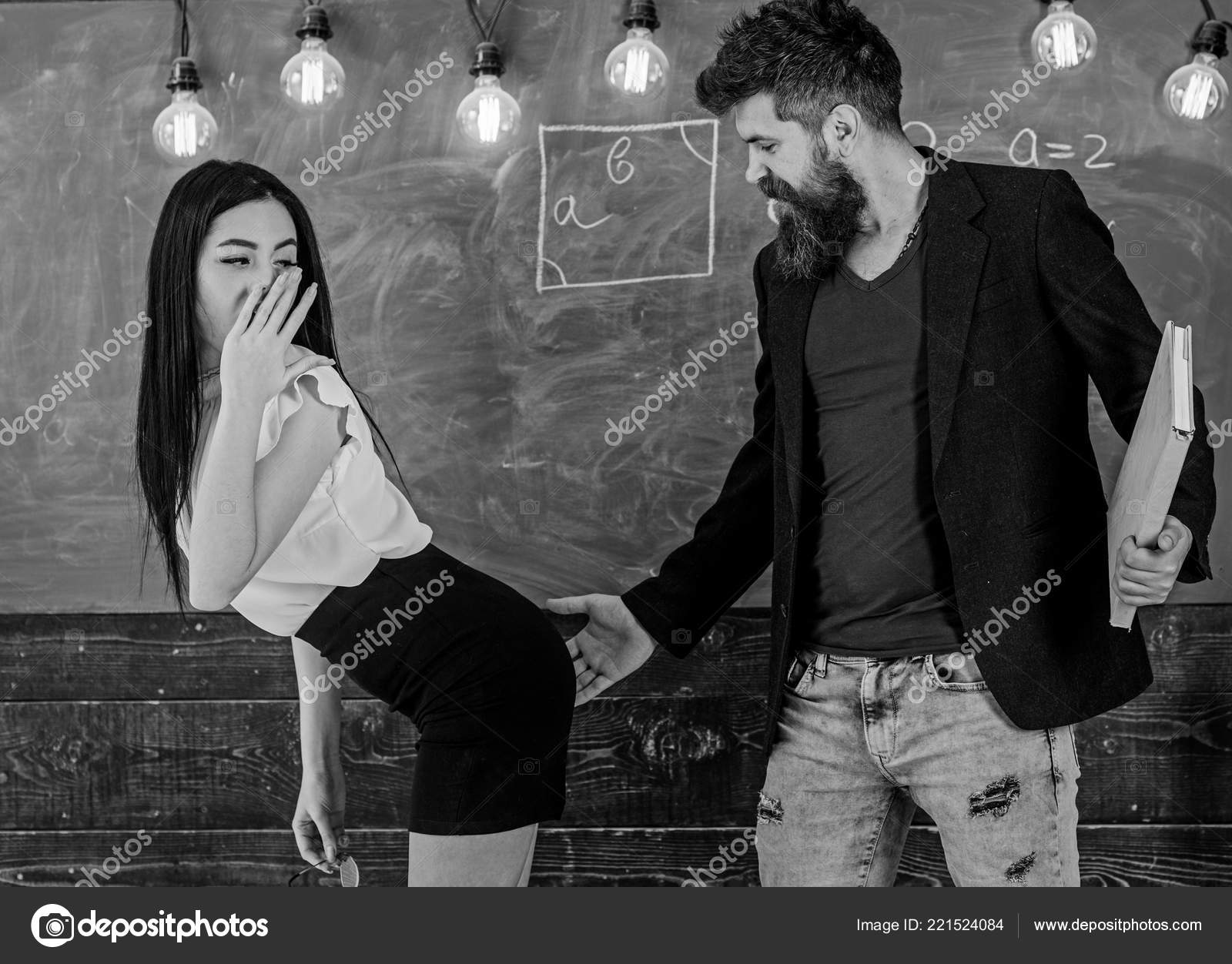 Schoolmaster punishes sexy student with slapping on her buttocks. Girl on guilty and helpless face punished by teacher. Man with beard slapping sexy student, chalkboard on background. Sex game concep Stock Photo Schoolmaster punishes sexy student with slapping on her buttocks. Girl on guilty and helpless face punished by teacher. Man with beard slapping sexy student, chalkboard on background. Sex game concep Stock Photo