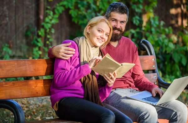 Information source concept. Couple with book and laptop search information. Share or exchange information knowledge. Man and woman use different information storage. Couple spend leisure reading