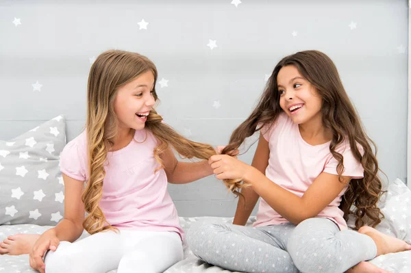 Children cheerful play with hair in bedroom. Happy childhood moments. Kids girls sisters best friends full of energy in cheerful mood. Grow strong and healthy hair. Hair care concept. Strong hair — Stock Photo, Image