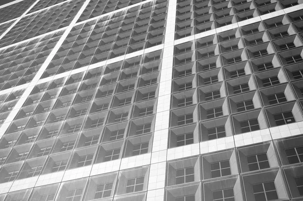 Stavební fasáda s okny z modrého skla. Moderní architektura a konstrukce. Konstrukce a design. Komerční nemovitost nebo nemovitosti. Perspektiva a budoucí koncepce — Stock fotografie