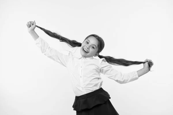 Happy girl show long brunette hair on yellow background. Little child smile with new hairstyle. Hairdresser salon services. Proud of her beautiful hair. Beauty salon. Stylish and cute — Stock Photo, Image