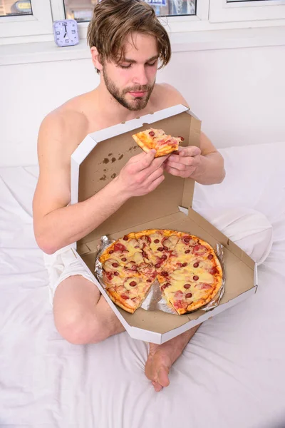 Guy naked covered pizza box sit bed bedroom offer you join him. Sexy courier delivers gastronomic satisfaction. Gastronomic satisfaction. Man bearded handsome eat pizza. Man eat pizza breakfast