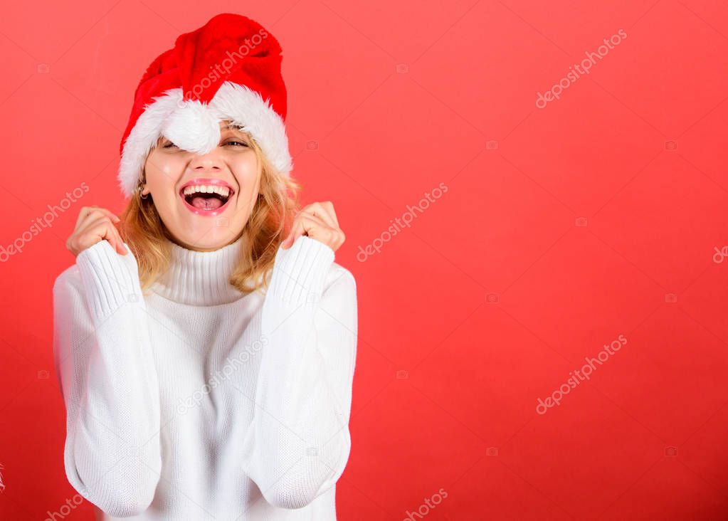 Christmas masquerade or karnival concept. Girl cheerful face celebrate christmas. Woman celebrate winter holiday christmas party. Woman in santa hat with pompon laughing red background copy space