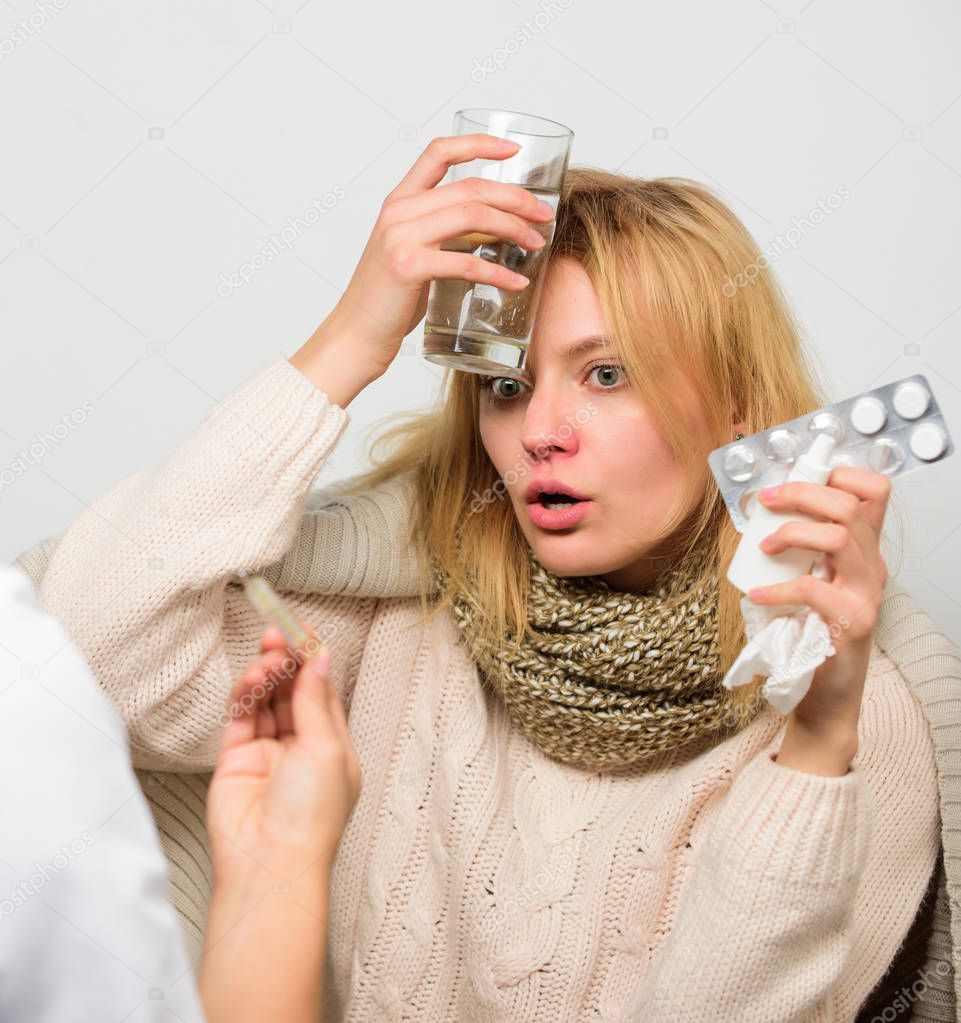 Flu and cold treatment. Girl in scarf examined by doctor. Fever and flu remedies. Woman consult with doctor. Doctor communicate with patient recommend treatment. Doctor ask patient about symptoms