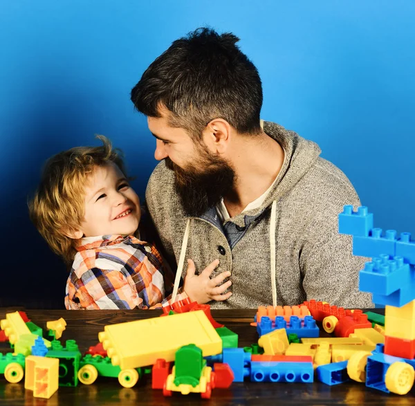 Family with cheerful faces build out of colored construction blocks — Stock Photo, Image