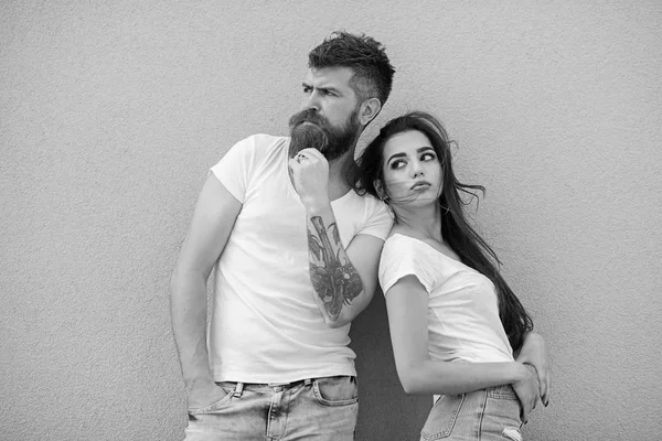 Couple stylish young modern people. Couple in love hang out together grey wall background. Urban loving couple. Couple white shirts lean each other. Hipster bearded and stylish girl hang out outdoors — Stock Photo, Image