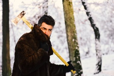 Kürk ceket omuz balta ile ormandaki adam