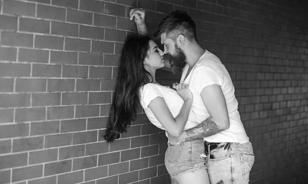 Couple enjoy intimacy without witnesses public place. Girl and hipster full of desire cuddling. Couple in love full of desire brick wall background. No rules for them. Couple find place to be alone — Stock Photo, Image