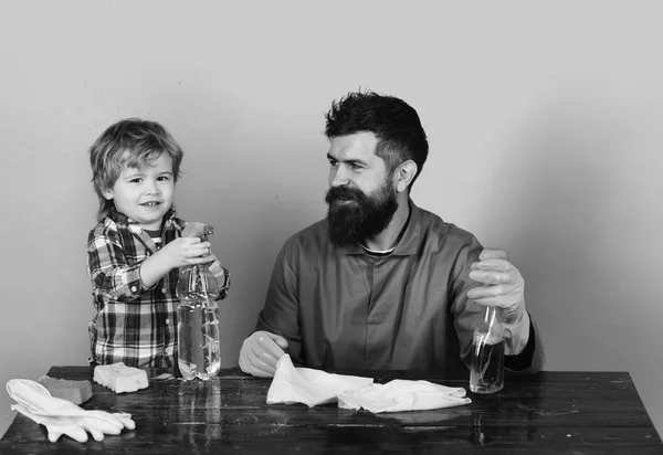 Guy with beard and mustache and kid in checkered shirt.