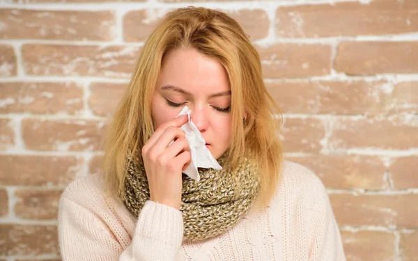 Runny nose symptom of cold. Tips how get rid of cold. Cold and flu remedies. Remedies should help beat cold fast. Woman feels badly ill sneezing. Girl in scarf hold tissue or napkin suffer headache