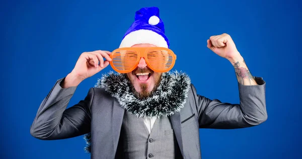 Corporate holiday party ideas employees will love. Corporate christmas party. Man bearded hipster wear santa hat and funny sunglasses. Manager tinsel ready celebrate new year. Christmas party office