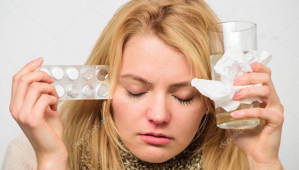 Guidelines for treating cold. Take medications to get rid of cold. Girl take medicine drink water. Headache and cold remedies. Woman tousled hair scarf hold tablets blister. Flu and cold concept