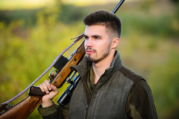 Masculine hobby activity. Hunting season. Man bearded hunter with rifle nature background. Experience and practice lends success hunting. How turn hunting into hobby. Guy hunting nature environment