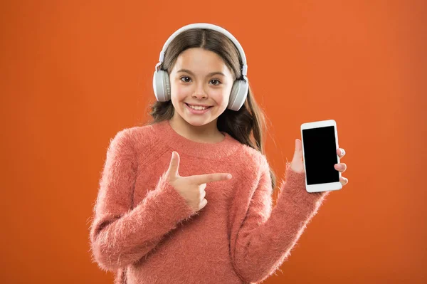 Girl child listen music modern headphones and smartphone. Listen for free. Get music family subscription. Access to millions of songs. Enjoy music concept. Best music apps that deserve a listen
